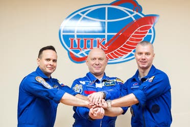 Russian cosmonauts Oleg Artemyev, Denis Matveev and Sergey Korsakov pose for a picture during a news conference ahead of the expedition to the International Space Station (ISS) at the Baikonur Cosmodrome, Kazakhstan March 17, 2022. (Reuters)