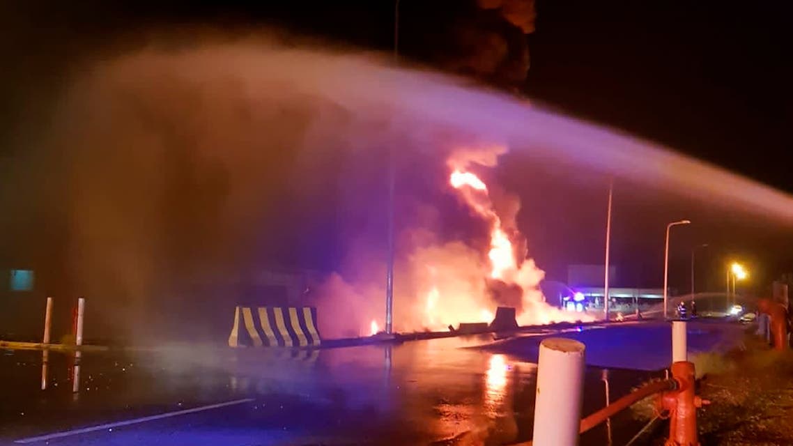 In this photo provided by the Saudi Press Agency, firefighters try to extinguish a blaze at an Aramco terminal in the southern border town of Jizan, Saudi Arabia, early Sunday, March 20, 2022. Yemen’s Houthi rebels unleashed a barrage of drone and missile strikes on Saudi Arabia early Sunday that targeted a liquified natural gas plant, water desalination plant, oil facility and power station, Saudi state-run media reported. (Saudi Press Agency via AP)