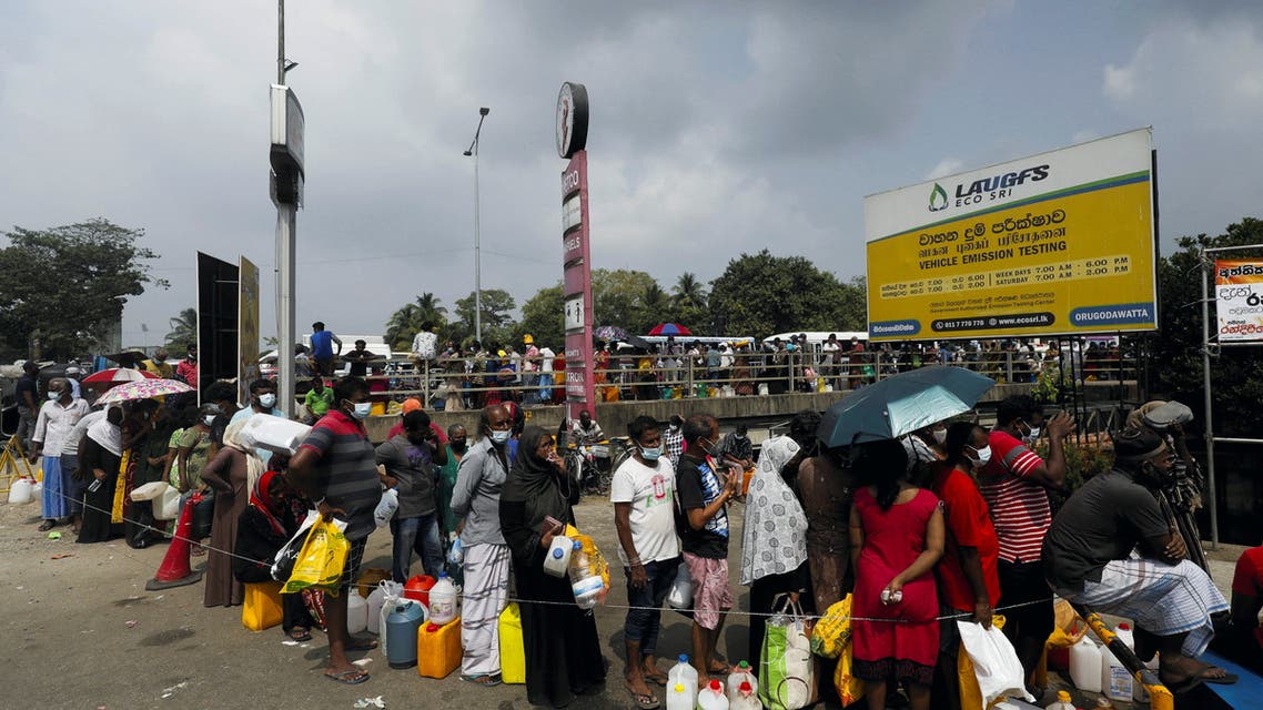 People stand in a long queue to buy kerosene oil due to shortage of domestic gas as a result of country's economic crisis, at a fuel station in Colombo, Sri Lanka March 18, 2022.(Reuters)