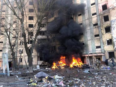 Smoke rises from burning vehicles outside a residential building that has been damaged by an airstrike, as Russia's attack on Ukraine continues, in Kyiv, Ukraine, in this handout picture released on March 20, 2022. (File photo: Reuters)