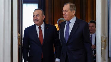 Russian Foreign Minister Sergei Lavrov and his Turkish counterpart Mevlut Cavusoglu enter a hall during a meeting in Moscow, Russia, on March 16, 2022.  (Reuters)