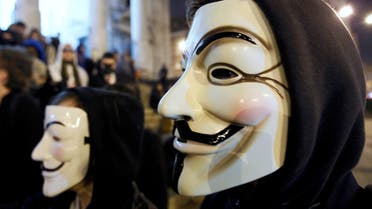 A protester wearing a Guy Fawkes mask, symbolic of the hacktivist group Anonymous, takes part in a protest in central Brussels January 28, 2012. (File Photo: Reuters)