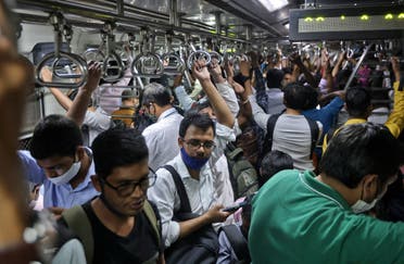 Commuters travel in a packed train in Mumbai, India, on February 25, 2022. (Reuters)