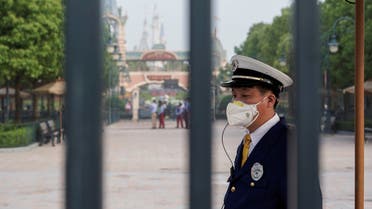 A security guard wears a face mask at Shanghai Disney Resort as the Shanghai Disneyland theme park reopens following a shutdown due to the coronavirus disease (COVID-19) outbreak, in Shanghai, China May 11, 2020. REUTERS/Aly Song