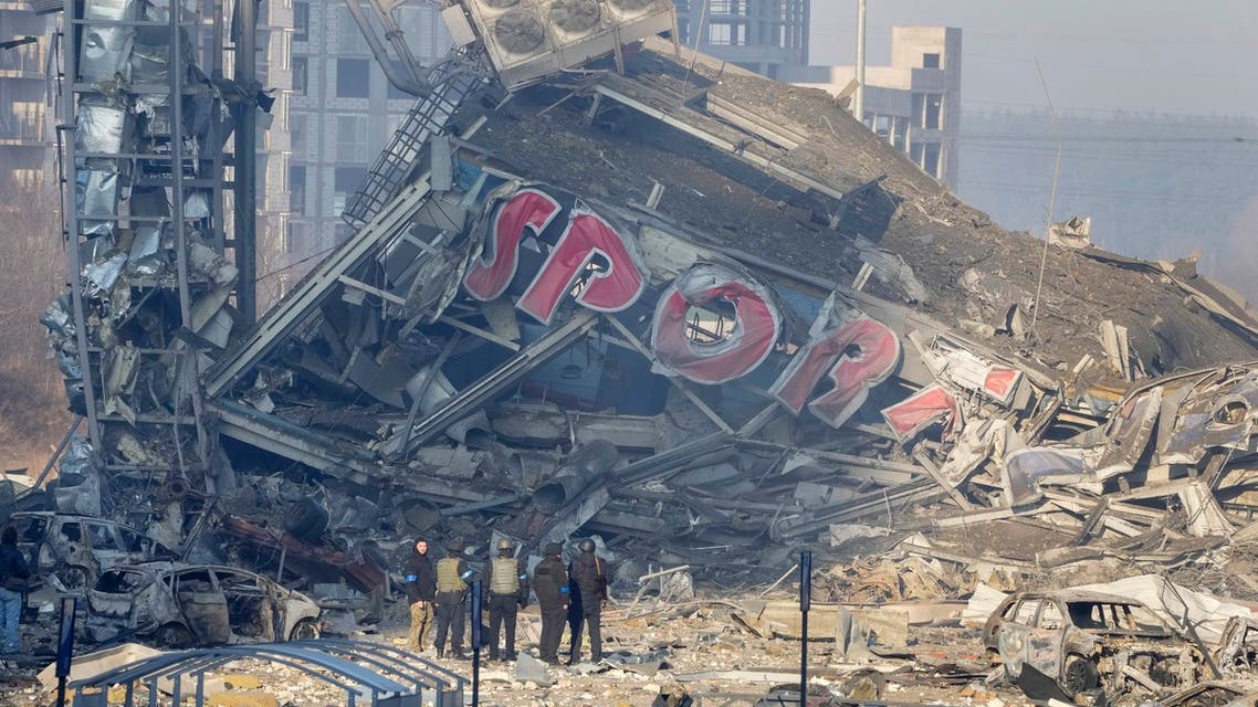 People examine the damage after shelling of a shopping center, in Kyiv, Ukraine, Monday, March 21, 2022. Eight people were killed in the attack. (AP Photo/ (AP Photo/Efrem Lukatsky)