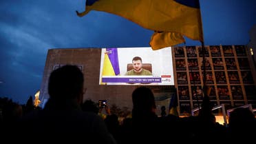 Demonstrators gather in support of Ukraine following Russia’s invasion, and watch Zelenskiy's speech as it is broadcasted to the Knesset, Israel's parliament, and projected at Habima Square in Tel Aviv, Israel, on March 20, 2022. (Reuters)