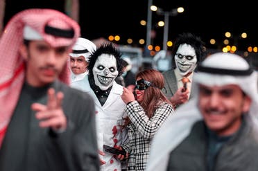 People dressed in costumes walk on a street, as they take part in a two-day costume event in Riyadh, Saudi Arabia, March 17, 2022. Picture taken March 17, 2022. (Reuters)