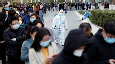People line up near a makeshift nucleic acid testing site outside a shopping mall during a mass testing for the coronavirus disease (COVID-19), in Beijing, China March 21, 2022. (Reuters)
