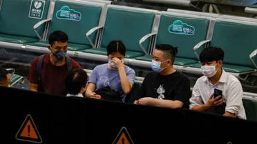 People sit in an area where relatives of the passengers of the China Eastern Airlines Boeing 737-800 plane, which crashed in Wuzhou flying from Kunming to Guangzhou, wait for news, at Guangzhou Baiyun International Airport in Guangzhou, Guangdong province, China March 21, 2022. (Reuters)