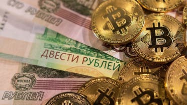 Russian rouble banknotes and representations of the cryptocurrency Bitcoin are seen in this illustration taken March 1, 2022. REUTERS