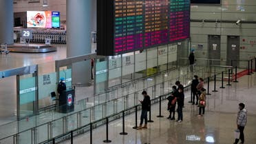 Travellers wearing face masks following the coronavirus disease (COVID-19) outbreak wait at check-in counters of Shanghai Hongqiao International Airport as the Spring Festival travel season begins ahead of the Chinese Lunar New Year, in Shanghai, China January 28, 2021. (Reuters)