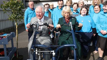 Britain's Prince Charles and Camilla, Duchess of Cornwall ride a vehicle in Cookstown, as they meet local businesses and members of the community during their two-day visit to Northern Ireland, March 22, 2022. (Reuters)