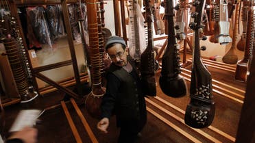 An Afghan man works in the musical instrument storage room at the Kabul Music Academy January 7, 2012. (Reuters)
