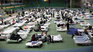 FILE PHOTO: People fleeing Russia's invasion of Ukraine rest in a temporary refugee centre located at a local track-and-field athletics stadium in Chisinau, Moldova March 4, 2022. REUTERS/Vladislav Culiomza/File Photo