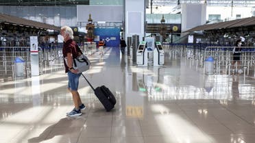 A foreigner walks inside the Bangkok's International Suvarnabhumi Airport as Thailand bans entry from 8 African countries due to the new Omicron variant of the coronavirus, Bangkok, Thailand, November 29. 2021. REUTERS/Chalinee Thirasupa