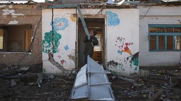 A man clears rubble at a damaged psychiatric hospital after it was hit in a military strike, as Russia's invasion of Ukraine continues, in Mykolaiv, Ukraine, March 22, 2022. REUTERS/Nacho Doce