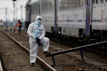 A health worker stands in front of a train run by Polish Red Cross, reserved for people who fled Russia's invasion of Ukraine and need medical care, to transport them to Wroclaw’s hospital, after they crossed the border from Ukraine to Poland, in Medyka, Poland, March 16, 2022. (Reuters)