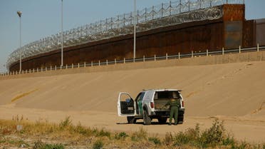 A U.S. Border Patrol agent removes a device commonly used as a ladder near the border wall during a mirror patrol, which simultaneously deploys Mexican police officers and U.S. Border Patrol agents along their respective sides of the border in response to an increased migrant influx in past days, February 26, 2022. (Reuters)