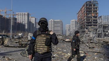 Ukrainian servicemen secure the site of a bombing at a shopping center as Russia's invasion of Ukraine continues, in Kyiv, March 21, 2022. (Reuters)