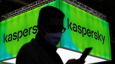 A man walks next to Russian Kaspersky stand during the GSMA's 2022 Mobile World Congress (MWC), in Barcelona, Spain, March 2, 2022. (Reuters)