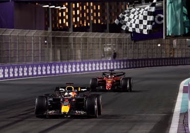 Red Bull’s Max Verstappen crosses the line to win the race ahead of Ferrari’s Charles Leclerc during the Formula One race in Jeddah on March 27, 2022. (Reuters)