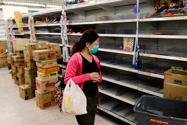 A customer wearing a face mask shops in front of partially empty shelves at a supermarket, ahead of mass coronavirus disease (COVID-19) testing, in Hong Kong, China March 4, 2022. (Reuters)