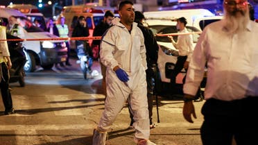 Israeli police forensic experts work at the scene of an attack in which people were killed by a gunman on a main street in Bnei Brak, near Tel Aviv, Israel, March 29, 2022. REUTERS/Nir Elias REFILE - QUALITY REPEAT