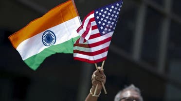 A man holds the flags of India and the U.S. while people take part in th India Day Parade in New York. (File photo: Reuters)
