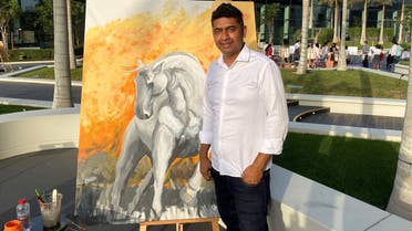 Roshan Perera with a work-in-progress at the Art in the Park exhibition in Index Mall, Dubai, on March 25 2022. (Al Arabiya English)