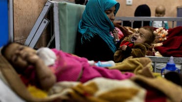 Farzana, 30, holds her one-year-old baby, Omar, at the malnutrition ward for infants of Indira Gandhi Children's hospital in Kabul, Afghanistan October 23, 2021. (File photo: Reuters)
