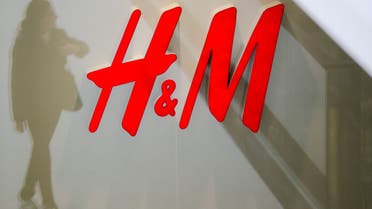 A woman is reflected next to the logo of the H&M fashion retailer in the newly opened Mall of Berlin shopping centre in Berlin, Germany, in this September 25, 2014 file photo. (File Photo: Reuters)
