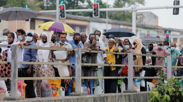 People stand in a long queue to buy kerosene oil for their kerosene cookers amid a shortage of domestic gas due to country's economic crisis, at a fuel station in Colombo, Sri Lanka March 21, 2022. (Reuters)