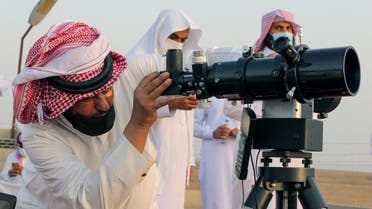 A member of the moon sighting committee looks through a telescope to view the moon ahead of Ramadan to mark the beginning of the holy fasting month, near Riyadh, Saudi Arabia, on April 12, 2021. (Reuters)