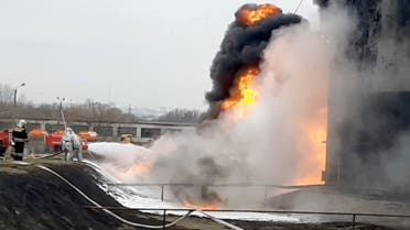 A still image taken from video footage shows members of the Russian Emergencies Ministry extinguishing a fire at a fuel depot in the city of Belgorod, Russia April 1, 2022. (Reuters)