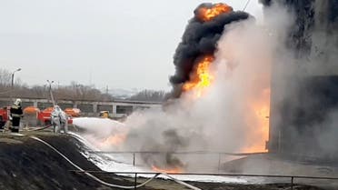 A still image taken from video footage shows members of the Russian Emergencies Ministry extinguishing a fire at a fuel depot in the city of Belgorod, Russia April 1, 2022. (Reuters)
