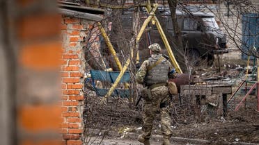 A Ukrainian soldier patrols in the village of Mala Rogan, east of Kharkiv, on March 30, 2022. (AFP)