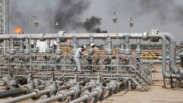 Workers adjust the valve of an oil pipeline at Nahr Bin Umar oil field, north of Basra, Iraq March 22, 2022. (Reuters)