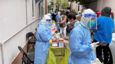 Medical workers in protective suits administer nucleic acid testing for residents in a residential compound, as the second stage of a two-stage lockdown to curb the spread of the coronavirus disease (COVID-19) begins in Shanghai, China April 1, 2022. (Reuters)