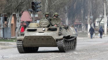 Service members of pro-Russian troops are seen atop of an armoured vehicle, which moves along a street in the course of Ukraine-Russia conflict in the southern port city of Mariupol, Ukraine April 1, 2022. (Reuters)