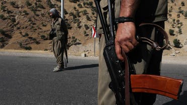 A member of the Kurdistan Workers' Party (PKK) carries an automatic rifle on a road in the Qandil Mountains, the PKK headquarters in northern Iraq, on June 22, 2018. Hundreds of Iraqi Kurds marched Friday to protest Turkish strikes against the Kurdistan Workers' Party (PKK) after Turkey's President Recep Tayyip Erdogan said Ankara would press an operation against its bases. (Photo by SAFIN HAMED / AFP)