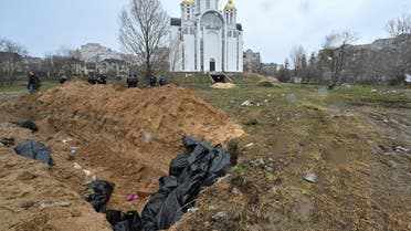 A mass grave is seen behind a church in the town of Bucha, northwest of the Ukrainian capital Kyiv on April 3, 2022. (AFP)
