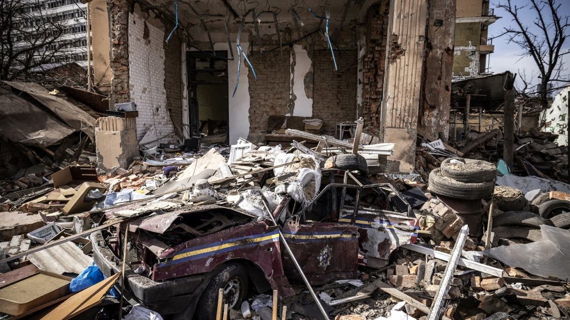 This photograph taken in the eastern Ukraine city of Kharkiv, on April 2, 2022, shows a police car under the rubble as Ukraine said today Russian forces were making a rapid retreat from northern areas around the capital Kyiv and the city of Chernigiv. (AFP)