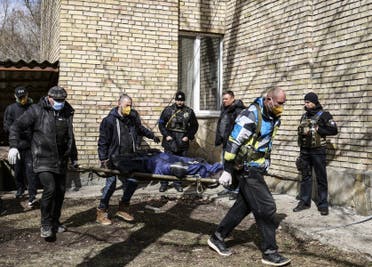 A body is carried at a school in Bucha, northwest of the Ukrainian capital Kyiv on April 4, 2022. (AFP)