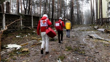 Red Cross staff walk next to damaged buildings and fallen branches as the humanitarian organisation delivers food and first aid to residents that have been affected by fighting during Russia's invasion of Ukraine, in Irpin, April 1, 2022. Picture taken April 1, 2022. International Committee of the Red Cross/Handout via REUTERS THIS IMAGE HAS BEEN SUPPLIED BY A THIRD PARTY. NO RESALES. NO ARCHIVES. MANDATORY CREDIT