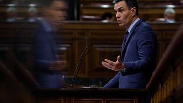 Spanish Prime Minister Pedro Sanchez is reflected on a wall as he speaks during a session at Parliament in Madrid, Spain, March 30, 2022. (Reuters)