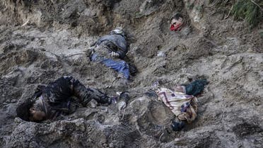 Bodies are seen in a mass grave in Bucha, northwest of the Ukrainian capital Kyiv on April 4, 2022. (AFP)