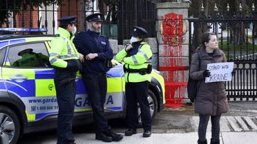Irish police officers stand outside the Embassy of Russia after it was defaced with red paint, in Dublin, Ireland, February 24, 2022. (Reuters)