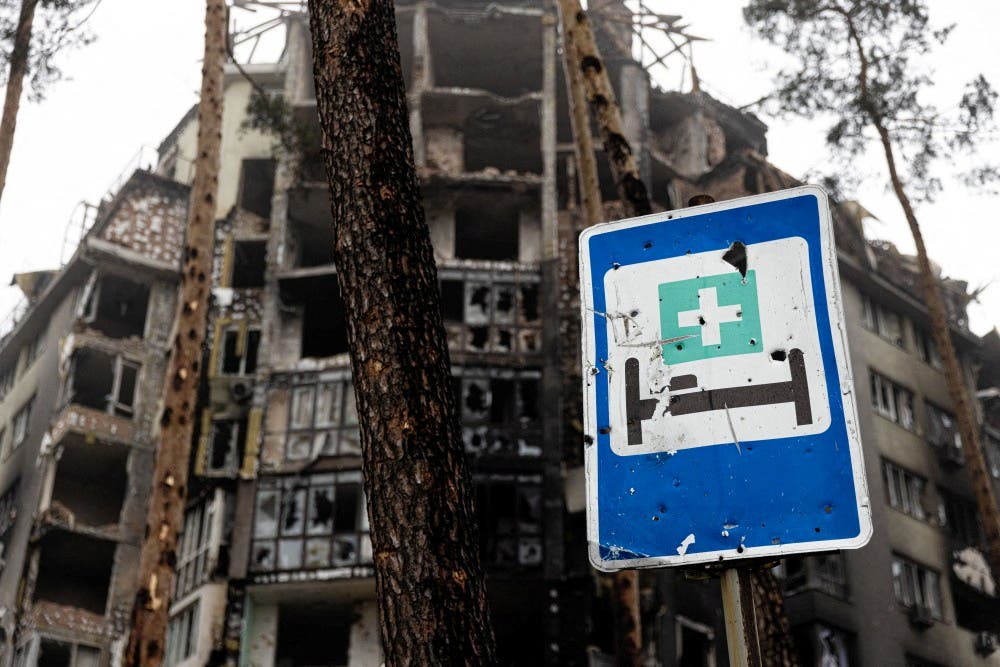 View of a damaged building with a hospital sign in the foreground as Red Cross staff (not pictured) deliver food and first aid to residents that have been affected by fighting during Russia's invasion of Ukraine, in Irpin, April 1, 2022. (File photo: Reuters)