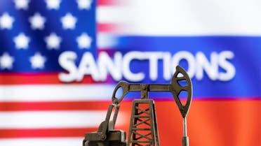 A model of a pump jack is seen in front of the displayed word Sanctions, U.S. and Russia flag colours in this illustration taken March 8, 2022. (Reuters)