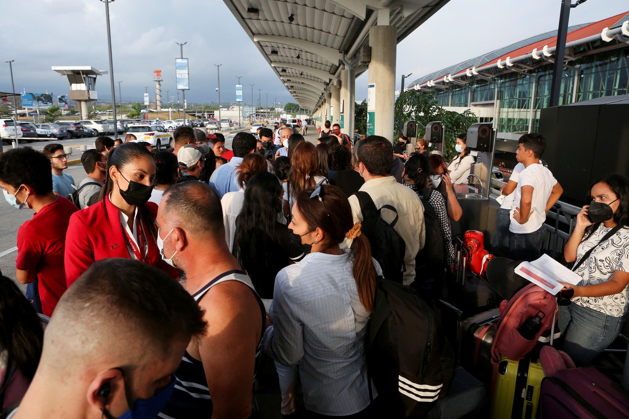 Passengers wait for information about their flights as Costa Rica's Juan Santamaria International Airport reopened after a Boeing 757-200 cargo aircraft operated by DHL made an emergency landing before skidding off the runway and splitting, aviation authorities said, in Alajuela, Costa Rica, April 7 , 2022. (Reuters)